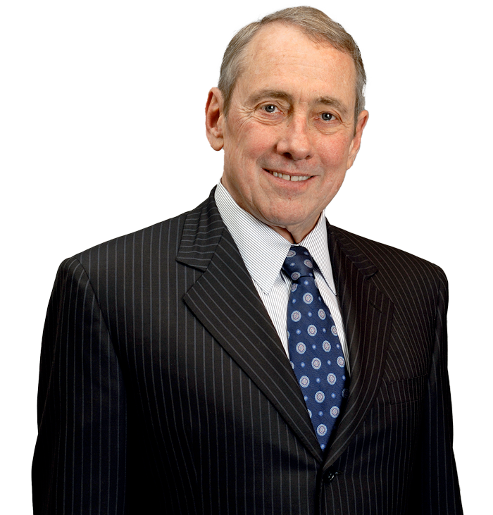 A headshot of a smiling person wearing a dark pinstripe suit, white shirt, and patterned blue tie.