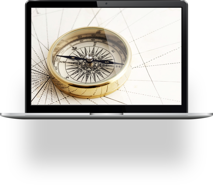 A laptop displays an image of a brass compass resting on a vintage nautical map, symbolizing navigation and exploration.