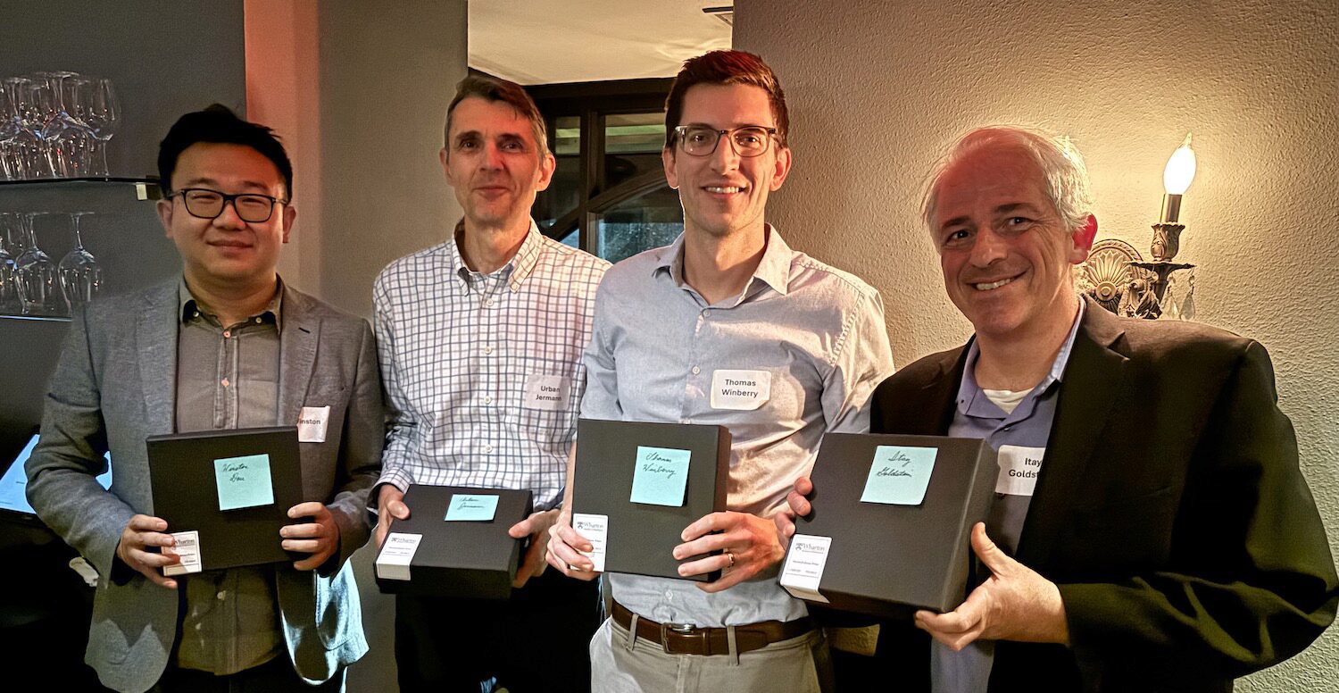 Four award recipients pose with their trophies.