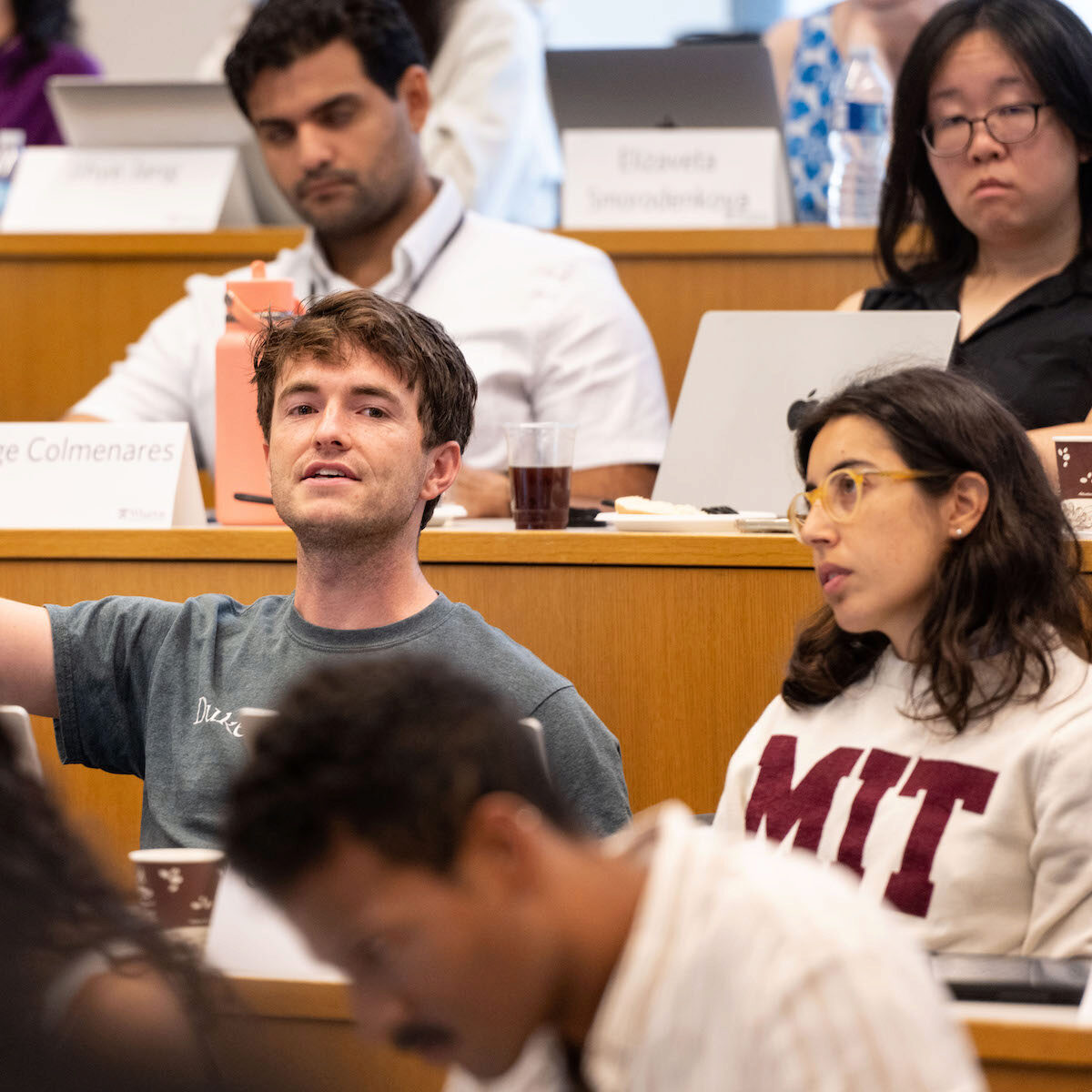 A student asks a question in a lecture hall